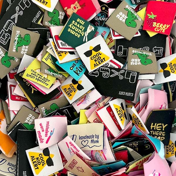 Colorful woven labels in a hand